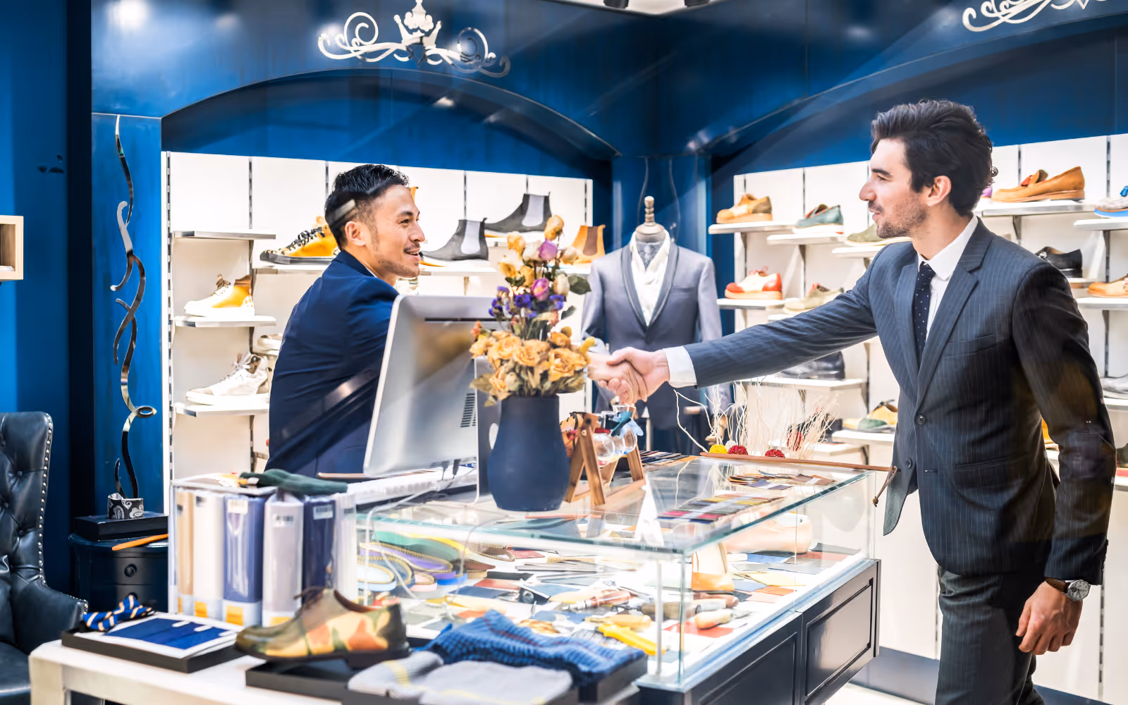 Small business owner shaking hands with a loyal customer, symbolizing customer lifetime value and long-term relationships built through loyalty programs.
